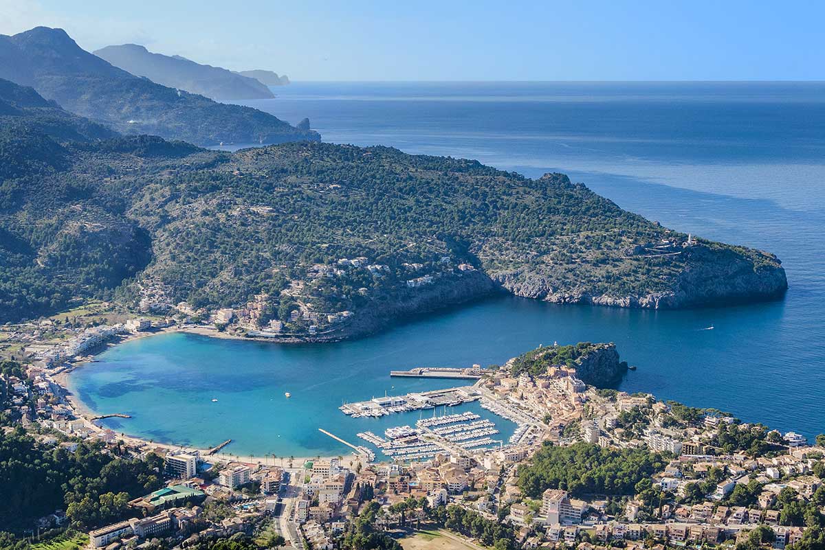 Aerial view of Puerto Soller's horseshoe-shaped bay and marina in Mallorca