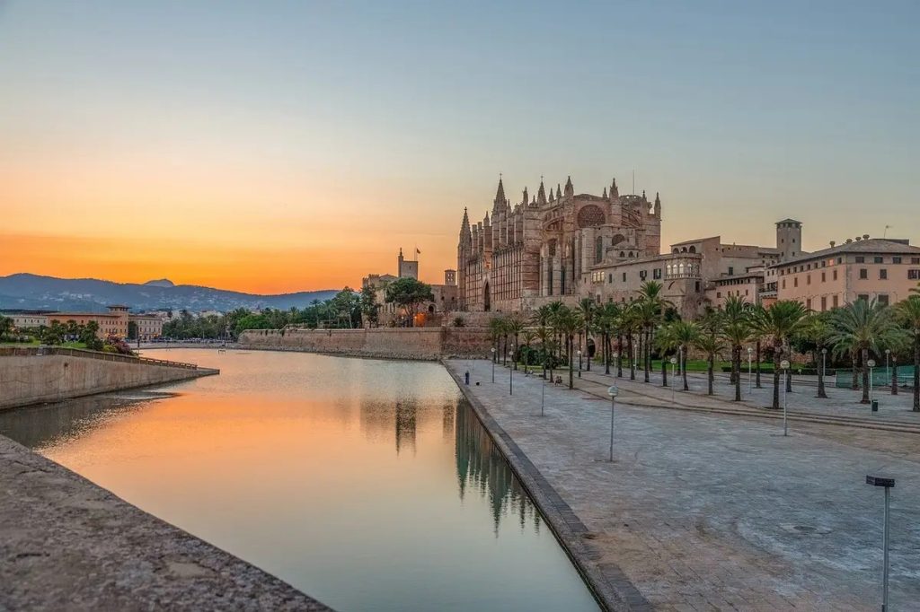 La Seu Cathedral and the Parc de la Mar lake in Palma at sunset