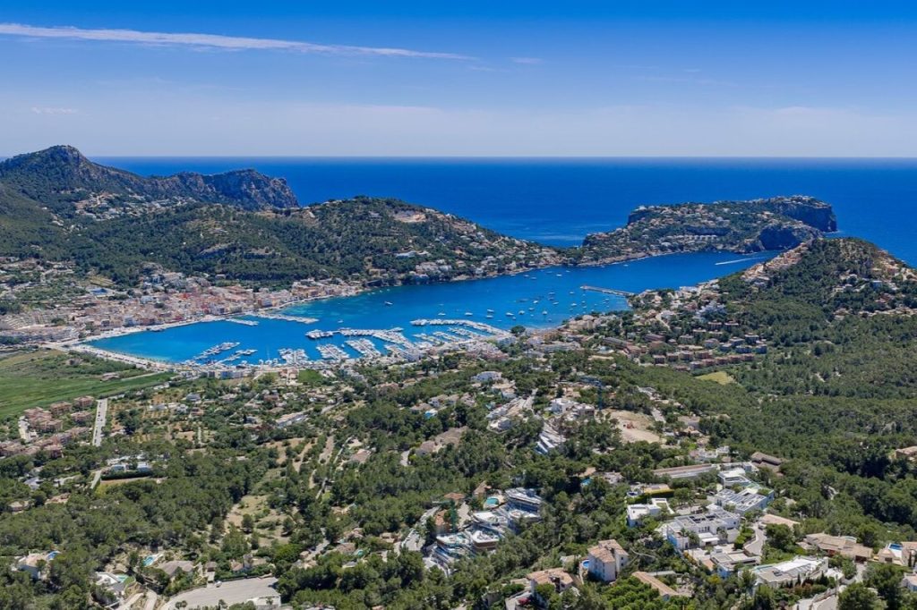 Aerial view of Port d'Andratx's harbour and La Mola in the background.
